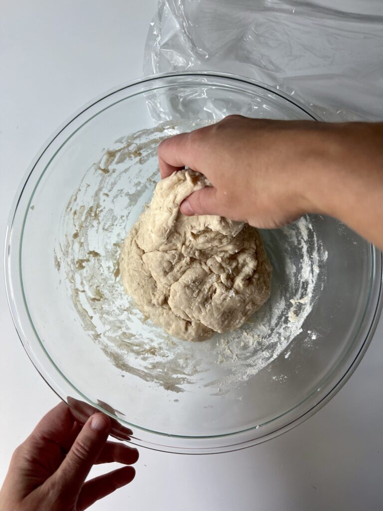To create strength, fold the dough into itself and press down repetitively. See below. 