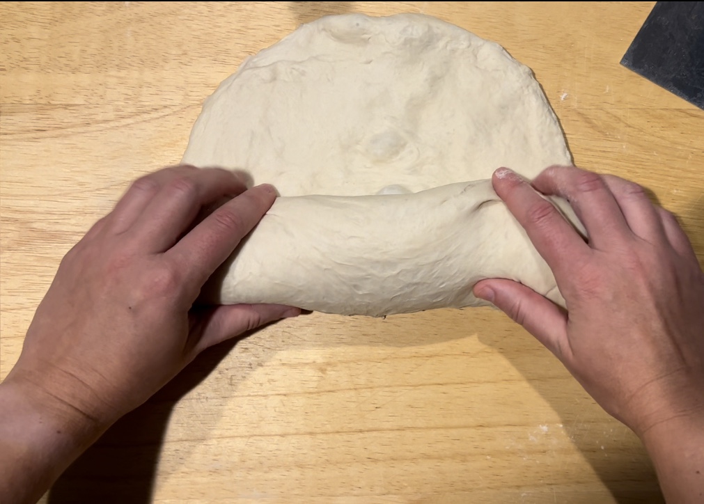Spread the dough out, roll it from the bottom, and tighten the seams