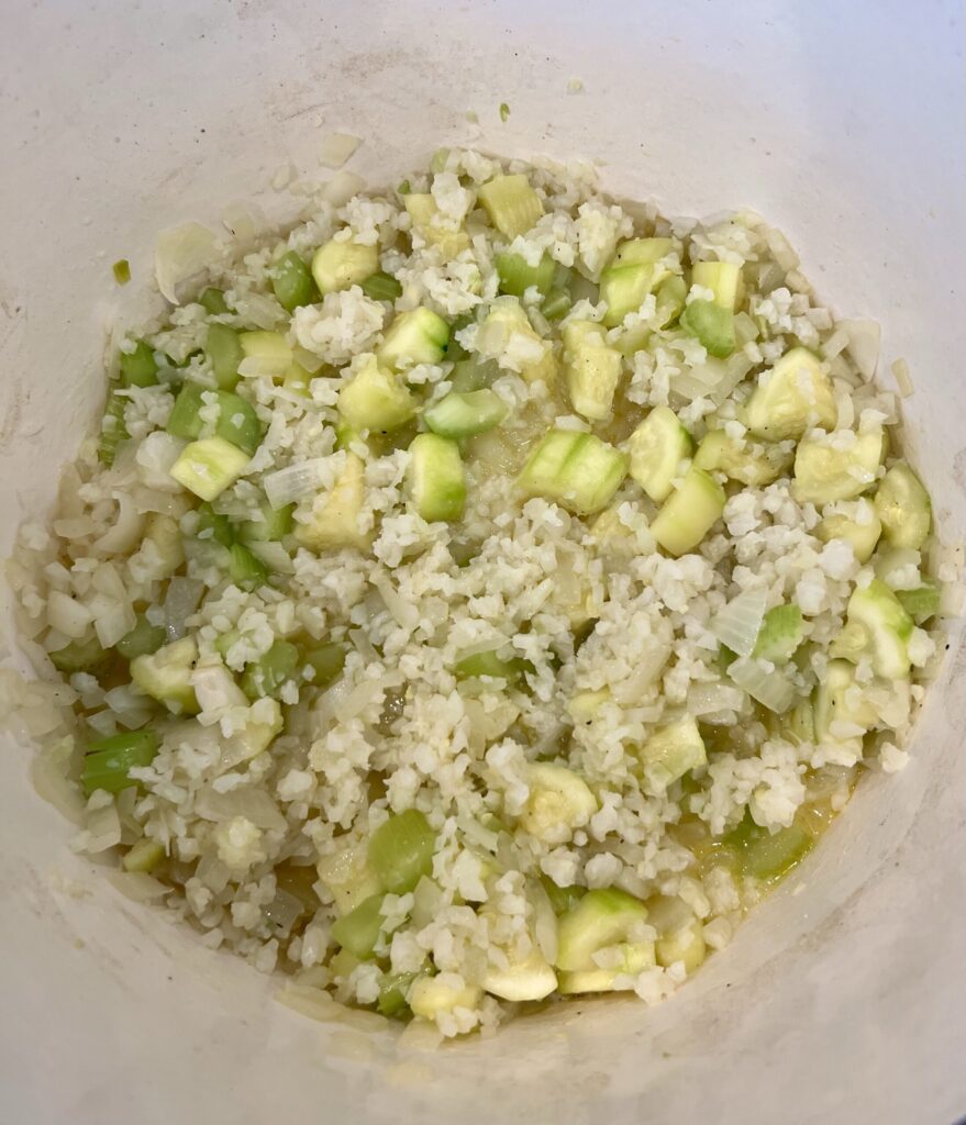 Add the cauliflower rice and broth