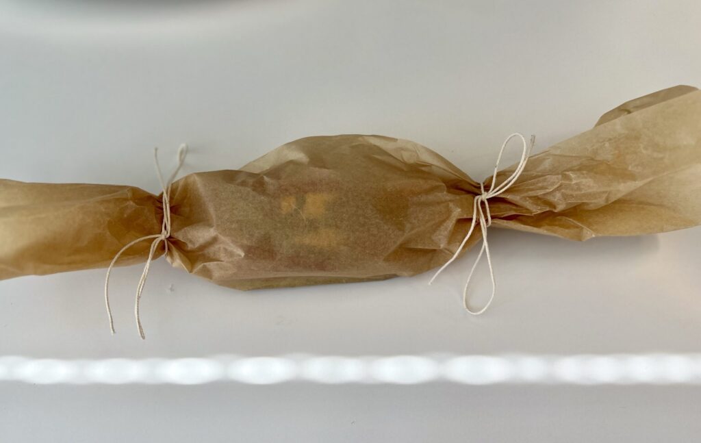 The key is to close up the parchment pouch as much as possible to create a perfect steaming environment. 