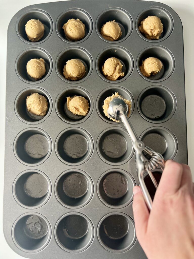 Place each 1-inch dough ball into the muffin pan