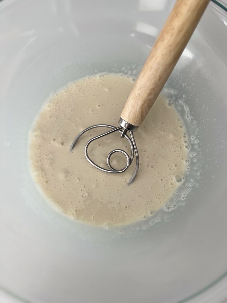 In a mixing bowl dissolve the sourdough starter and honey in warm water (or milk if using). 