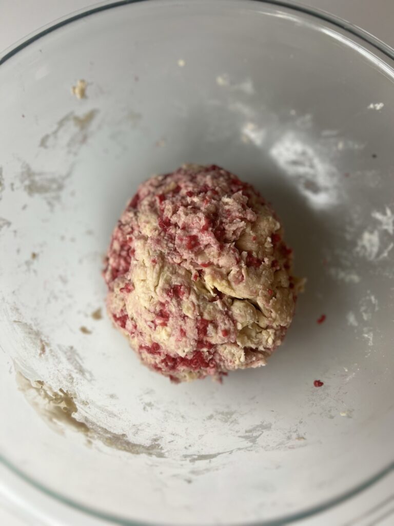 The dough should be stiff and crumbly, if it feels too wet which can result from the raspberries add a little more flour. 