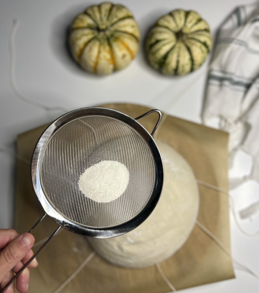 Next, sift some rice flour over the top of the dough to ensure the twine won't stick, this will also help your design pop!