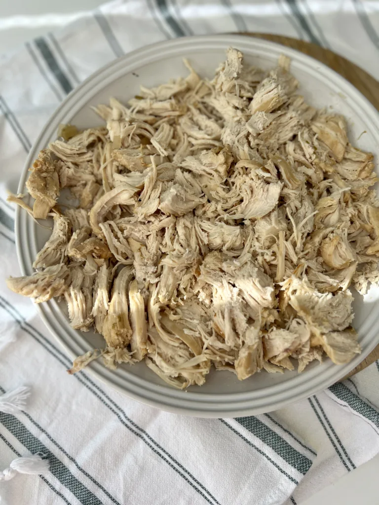 Once the pin drops, remove the instant pot lid and remove the chicken breasts to shred them with a fork and knife. 