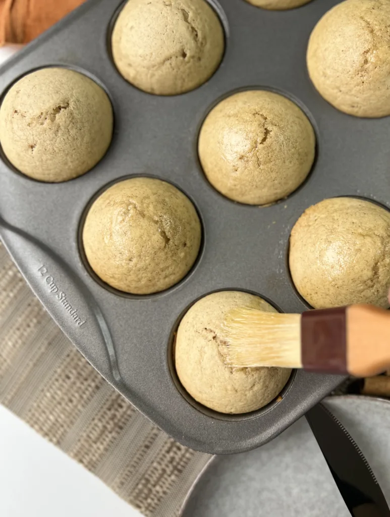 Brush each muffin with the melted butter and generously dust or dip the muffin in the cinnamon sugar mixture.