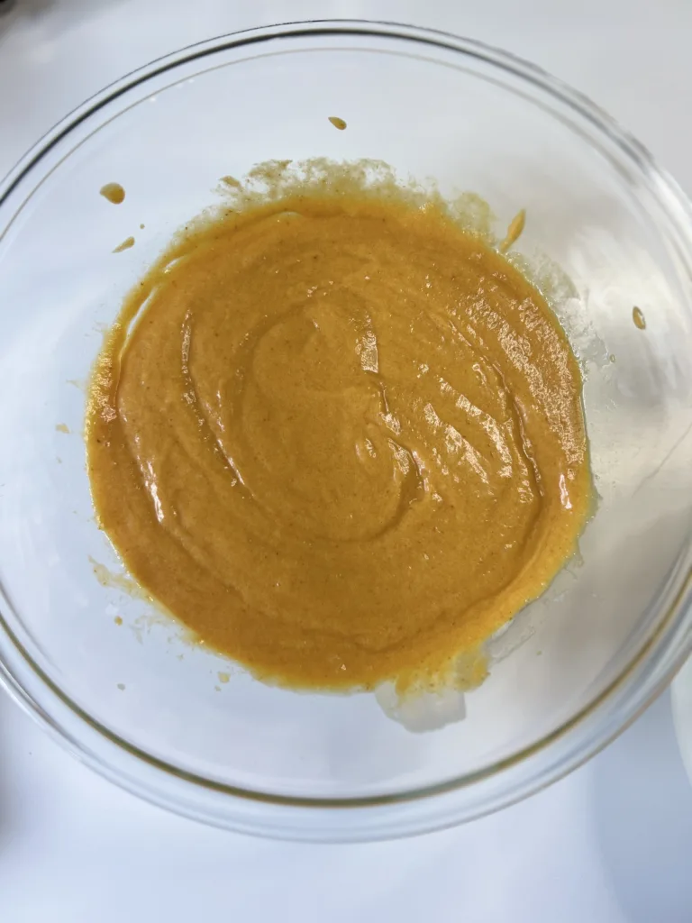 Next, add the sourdough discard, pumpkin puree, eggs, and vanilla extract and beat on low speed until everything comes together. 