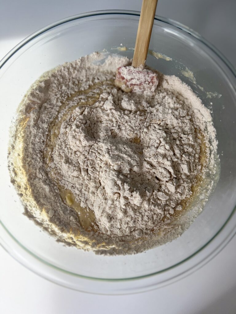 Gradually fold in the dry mixture to the wet and mix until no more flour streaks are visible. Do not overmix here. It is okay if the batter is a bit clumpy. 