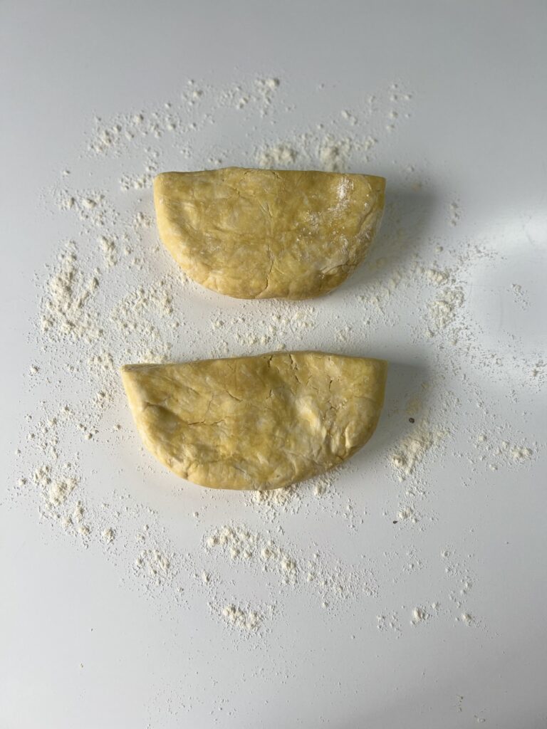 Place the dough on a liberally floured surface and cut it in half (if using 2 crusts).