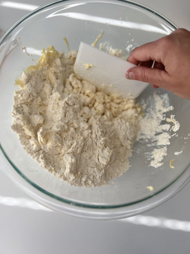 Using a pastry cutter, bench scraper, or fork cut the butter into the dry mixture until it resembles coarse crumbs. 