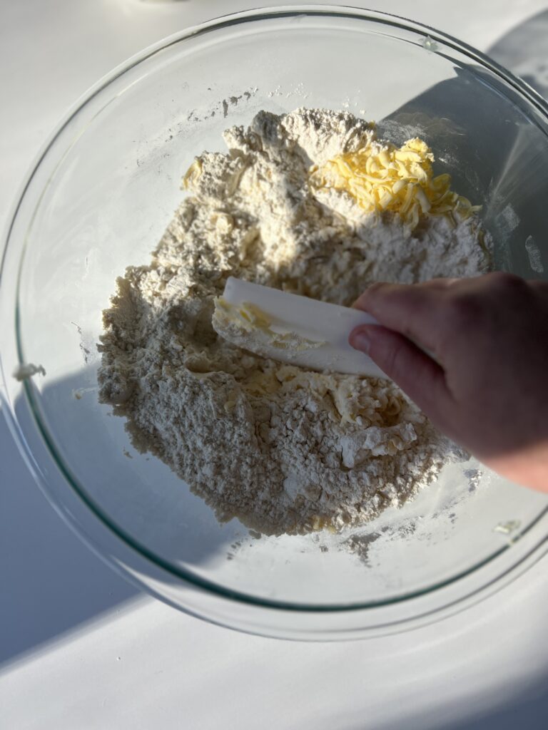 cutting the butter into the dough