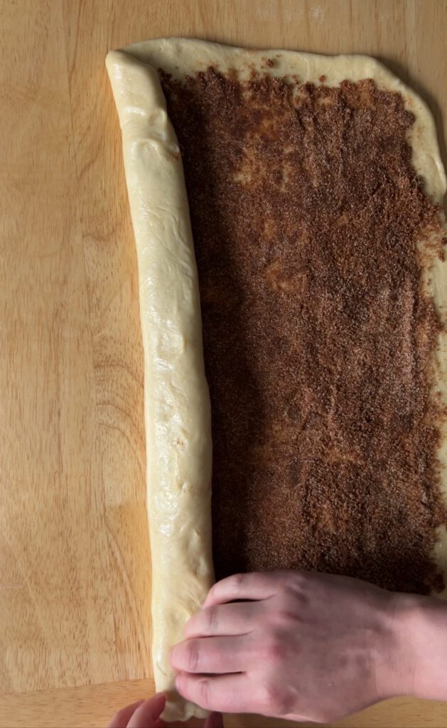 shaping sourdough cinnamon roll dough