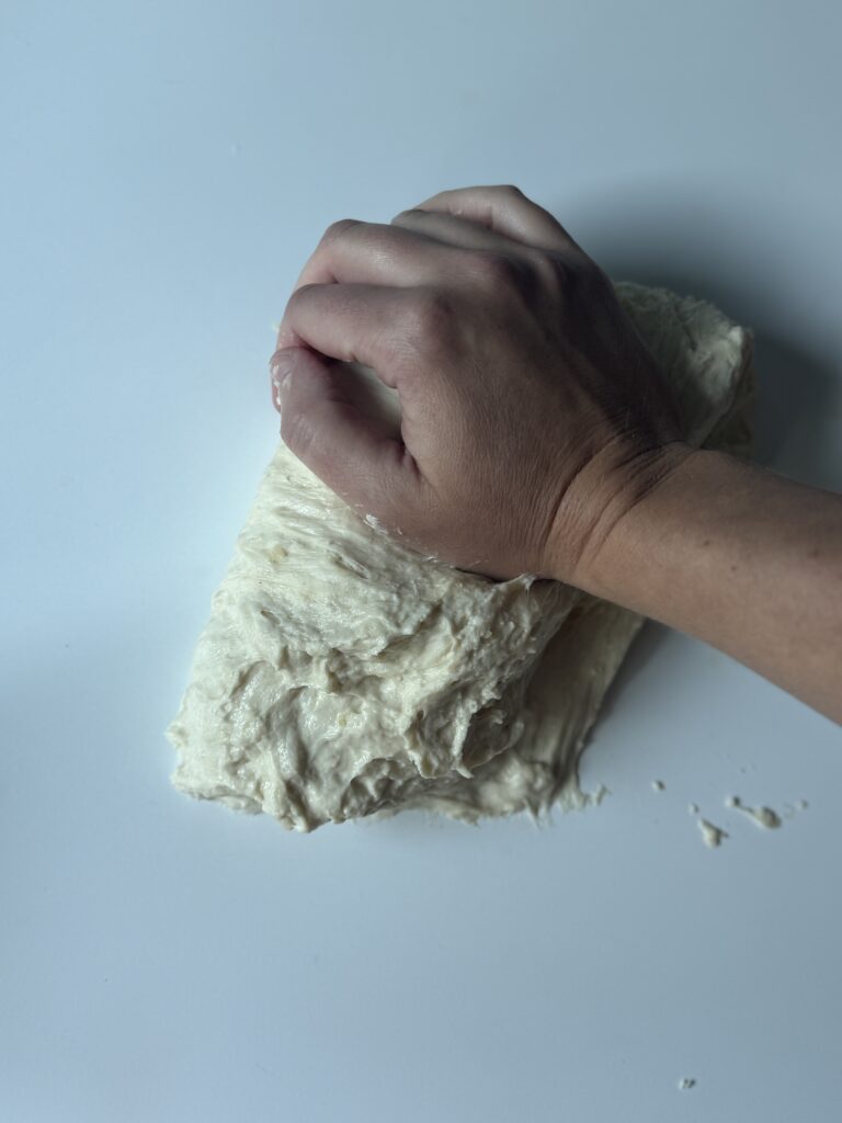 kneading sourdough french bread dough