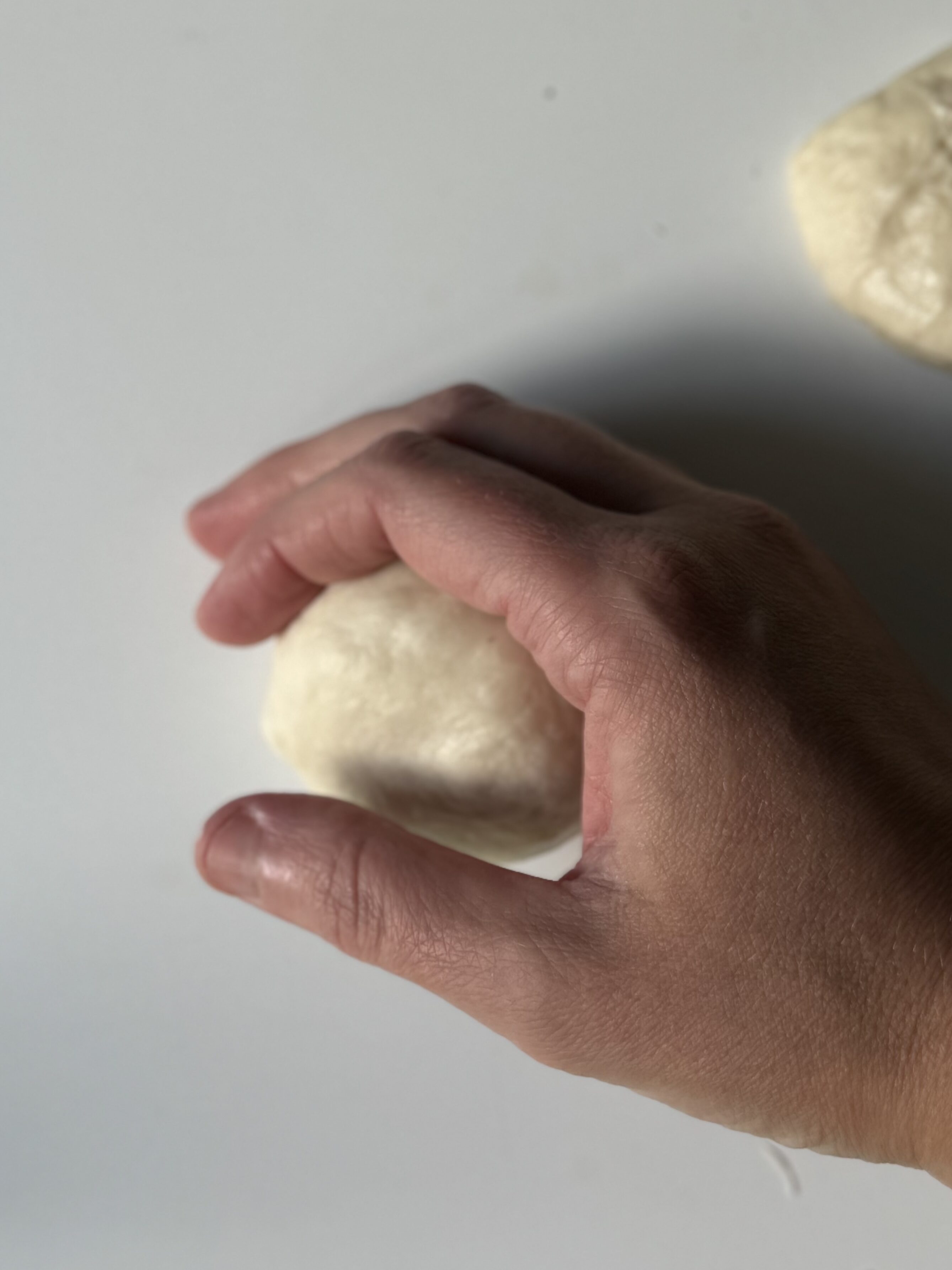 smoothing the dough ball out