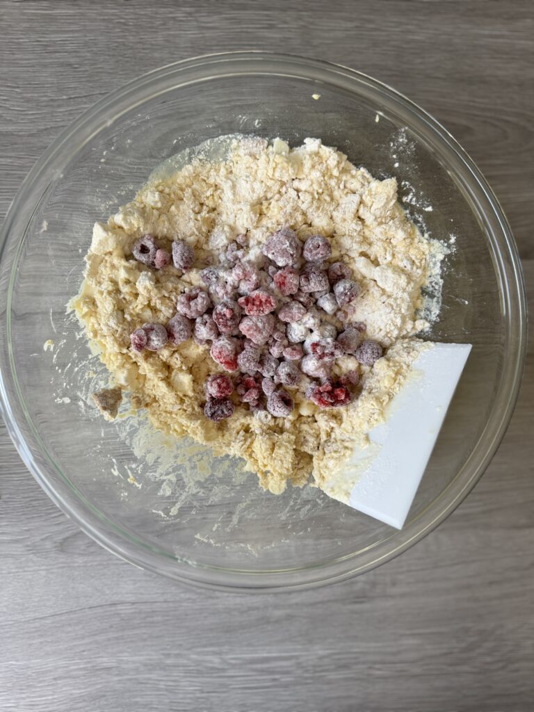 mixing raspberry cheesecake scones