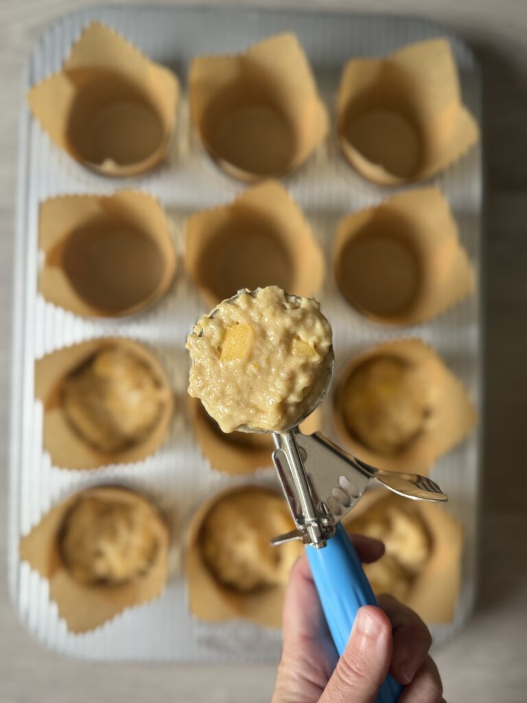 scooping peach muffins