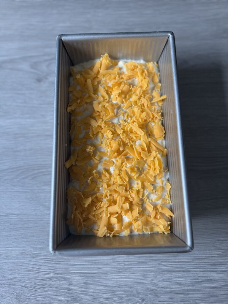 savory sourdough mixture in bread pan