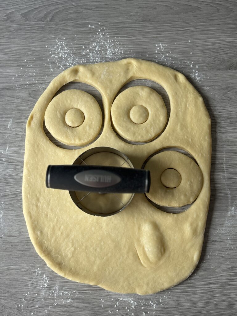 rolling out the donut dough