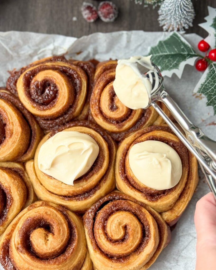 frosting the cinnamon rolls