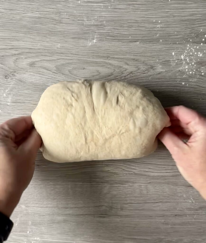 shaping sourdough honey wheat sandwich bread
