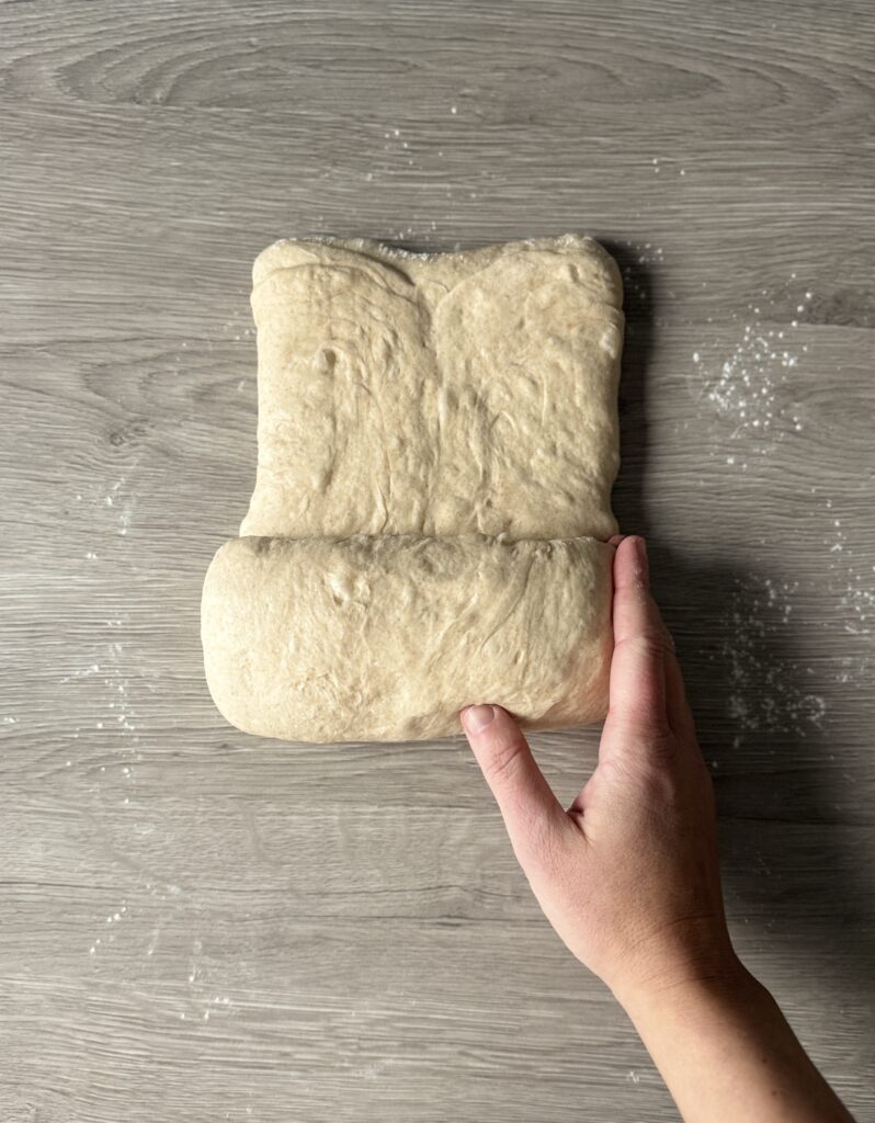 shaping sourdough honey wheat sandwich bread