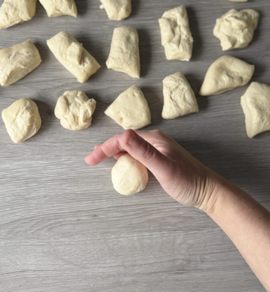 shaping football bread rolls