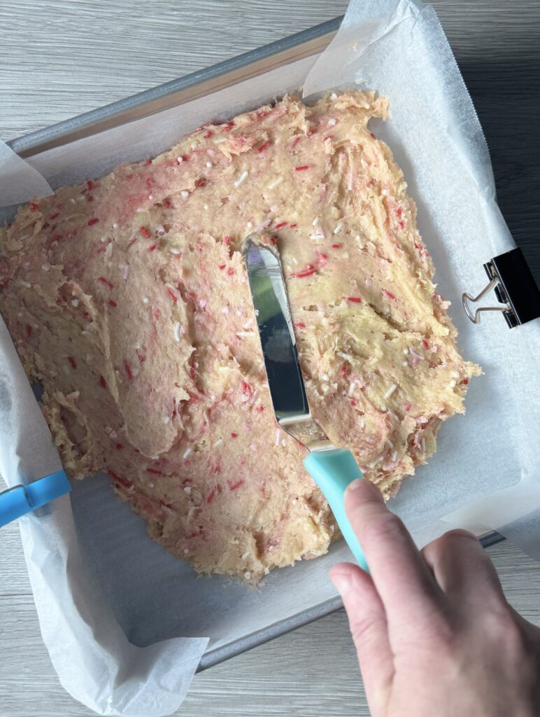 spreading sugar cookie bar dough