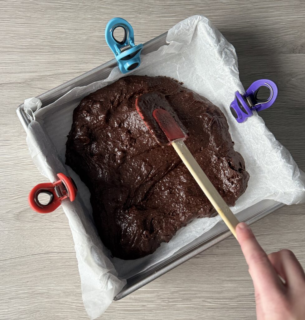 spreading brownie batter