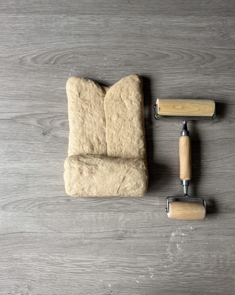 shaping honey wheat sourdough sandwich bread