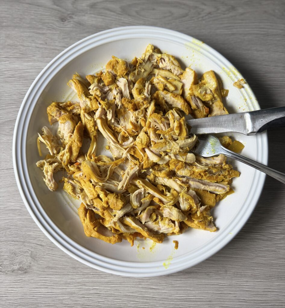 shredding chicken for turmeric soup