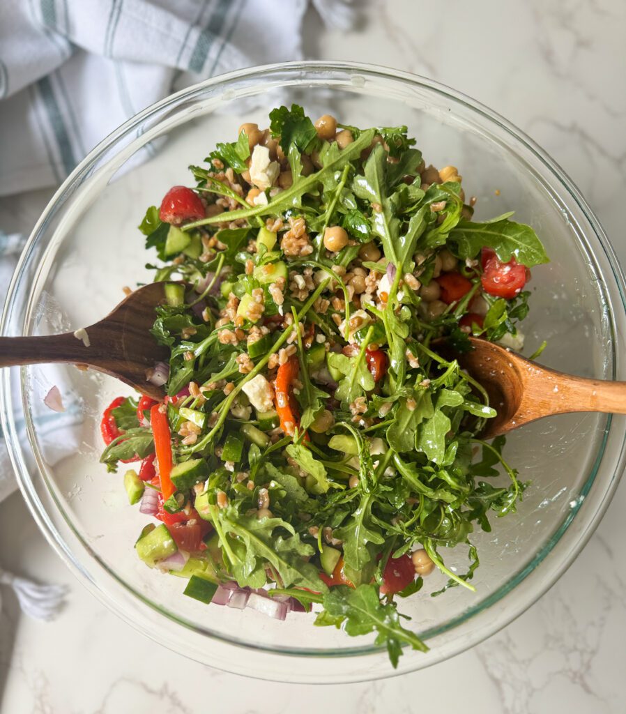 assembling Greek farro salad