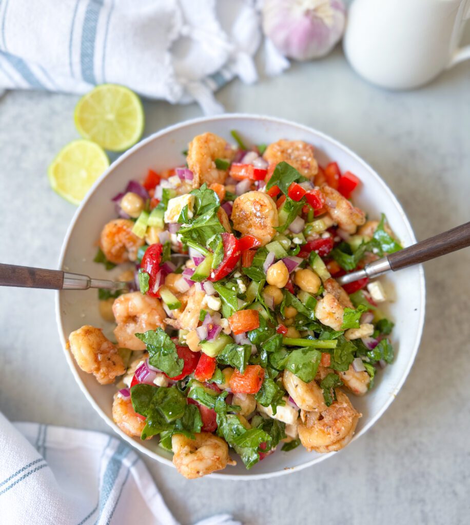 mixing Greek shrimp salad