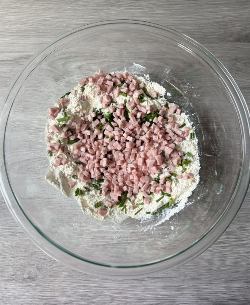 mixing ham cheddar and chive biscuit bombs